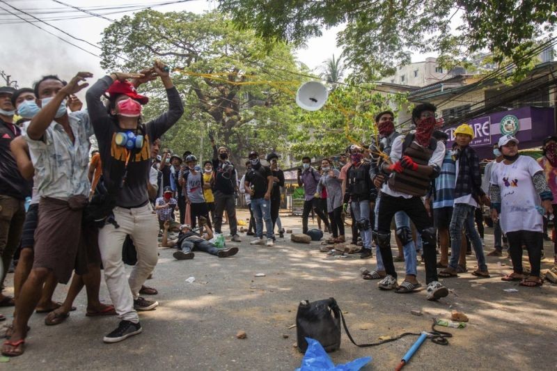 Protesters launch rocks during a rally against the military coup Saturday, March 27, 2021, in Yangon, Myanmar.  (AP Photo)