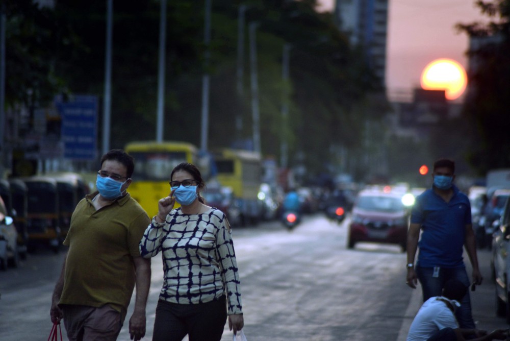 People wear masks, walk on a street during a nationwide lockdown| PTI File Photo