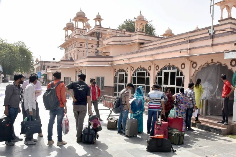A health worker takes swab samples of passengers, arriving from Mumbai, for COVID-19 testing at Bikaner Railway Station, in Bikaner on March 24, 2021. (PTI Photo)