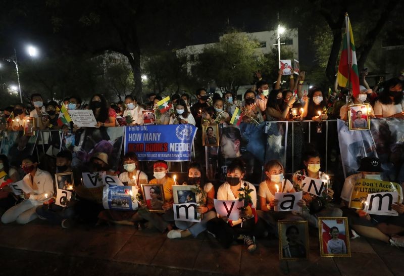 Myanmar nationals living in Thailand hold a candle light vigil as they protest against the military coup in front of the United Nations building in Bangkok, Thailand on March 4, 2021.  (AP/PTI Photo)