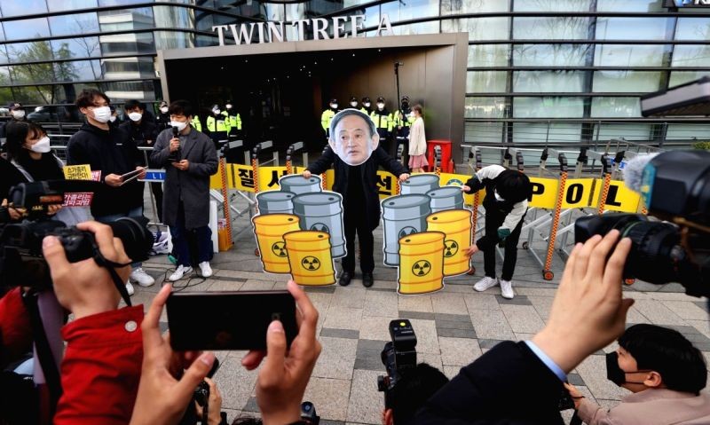 South Korean civic activists hold placards as they take part in a protest in front of the Japanese Embassy in Seoul against the Japanese government's decision to discharge radioactive water from the crippled Fukushima nuclear power plant. (IANS Photo)