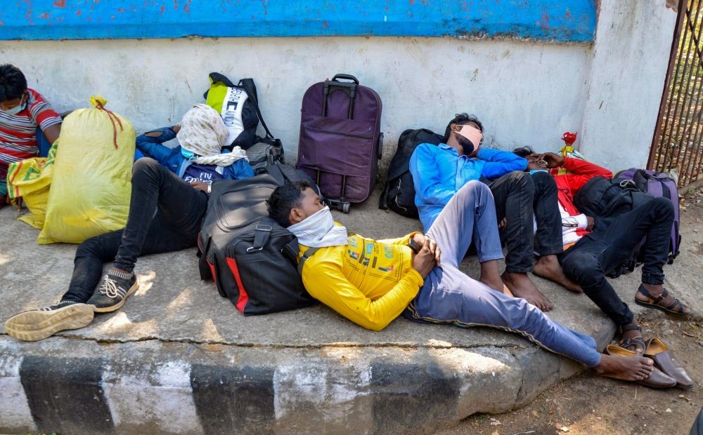 Ranchi: Migrants arriving from Maharashtra and Raipur wait for transportation to their home town at Hatia railway station amid second wave of coronavirus pandemic in Ranchi,Saturday, April 10,2021. (PTI Photo) 
