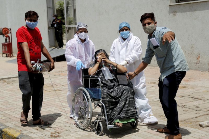 Ahmedabad: Health workers move a stable patient to another hospital to make space for critical COVID-19 patients, at Government Civil Hospital in Ahmedabad, Sunday, April 18, 2021. (PTI Photo)