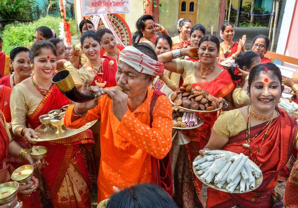 Tezpur: Women perform 'Uruka' rituals on the occasion of 'Rongali Bihu' festival, at Tezpur in Sonitpur district, Tuesday, April 13, 2021. (PTI Photo)