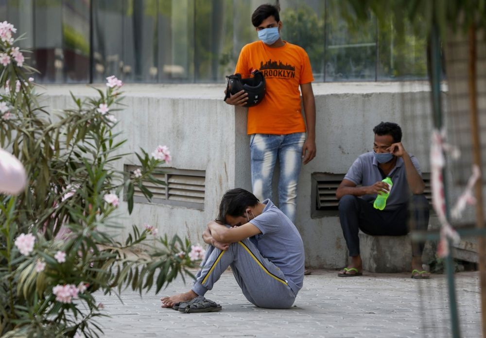 Ahmedabad: Relatives of a COVID-19 victim mourn outside the mortuary of a COVID-19 hospital in Ahmedabad, Thursday, April 15, 2021. (PTI Photo)  