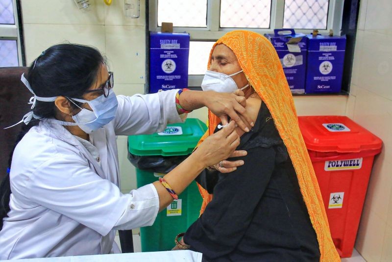 A beneficiary receives a dose of COVID-19 vaccine, in Jaipur on April 11, 2021. (PTI Photo)