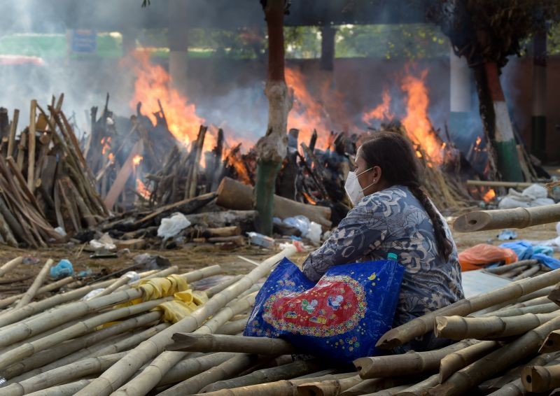 A family member during mass cremation of Covid-19 victims and others takes place at Gazipur Crematorium, in New Delhi on April 26, 2021. (PTI Photo)
