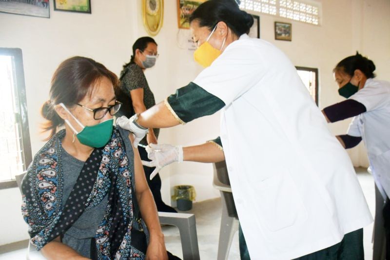 The first beneficiary getting vaccinated at Diphupar Village Council Hall. (DIPR Photo)
