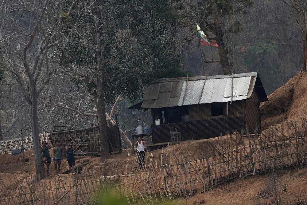 In this March 30, 2021, file photo, Myanmar soldiers stand at a small army camp along the river bank near the border of Myanmar and Thailand (AP Photo)