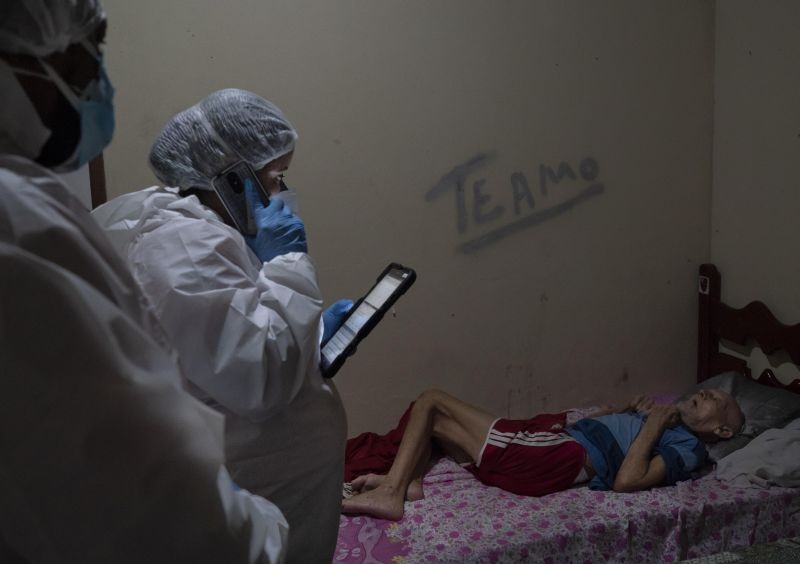 Duque de Caxias: Mobile Emergency Care Service (SAMU) worker Aline Moreira checks on an elderly COVID-19 patient before transferring him to a hospital in Duque de Caxias, Rio de Janeiro state, Brazil, Wednesday, April 7, 2021. AP/PTI