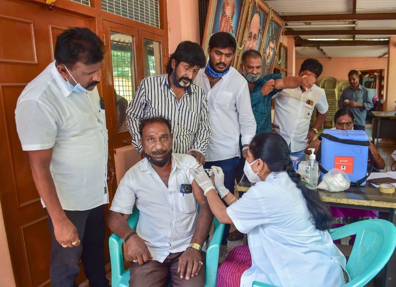 A medic administers the COVID-19 vaccine to a film supportive artist, amid surge in corona virus cases across the country, in Bengaluru on April 18. (PTI Photo)