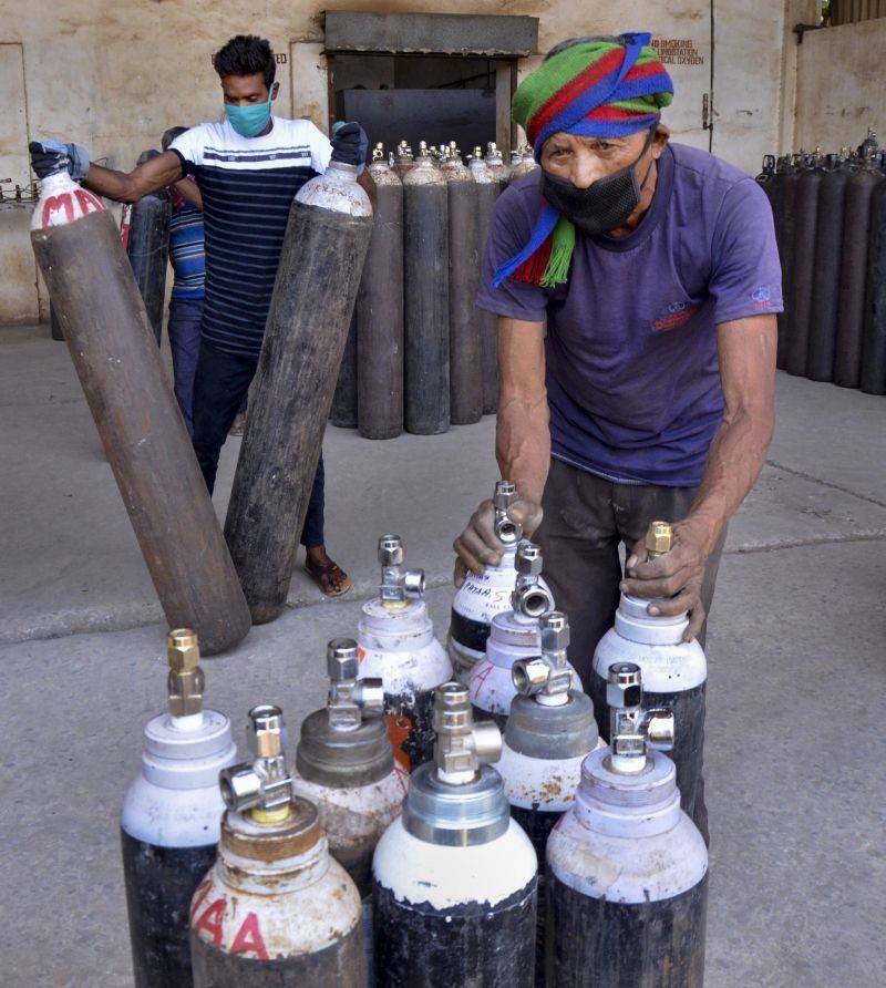 Workers arrange oxygen cylinders being transported to hospital for Covid-19 patients, amid the rise in Covid-19 cases across the country, in Ranchi on April 19. (PTI Photo)