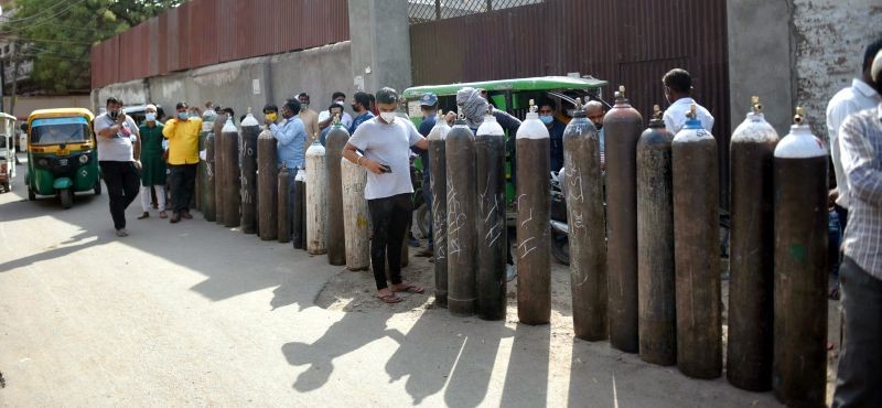 Family members of COVID-19 patients wait to refill cylinders with medical oxygen at a plant, as coronavirus cases surge in Lucknow on April 20, 2021. (PTI Photo)