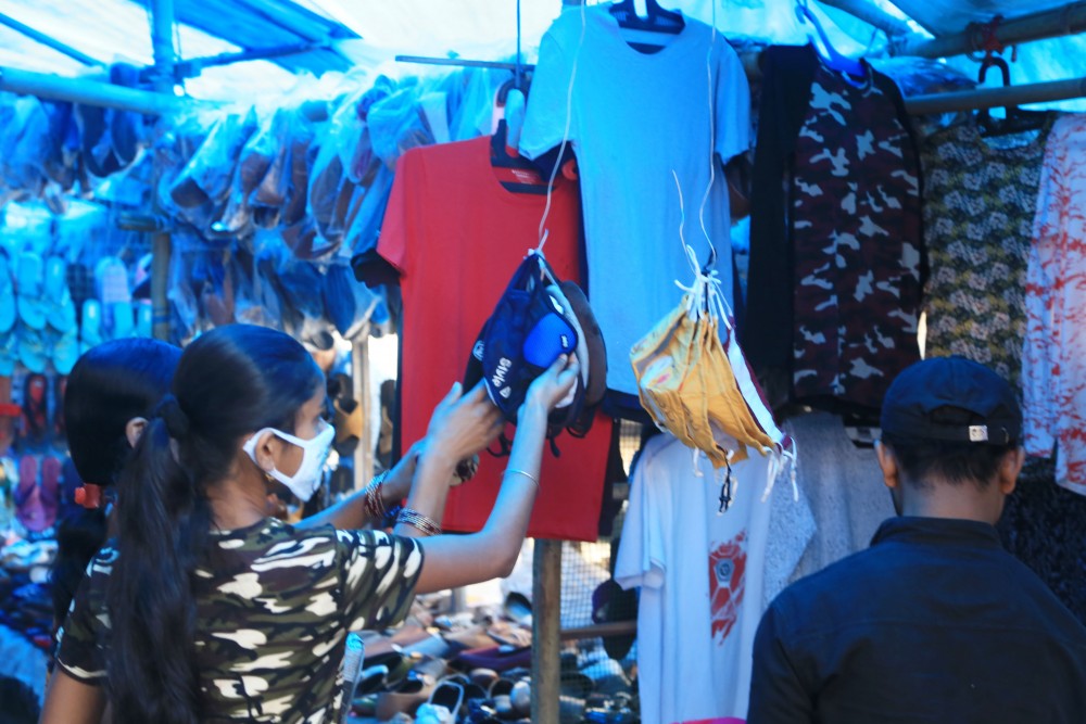 Customers are seen checking out masks at a pavement shop in Dimapur. (Morung File Photo)