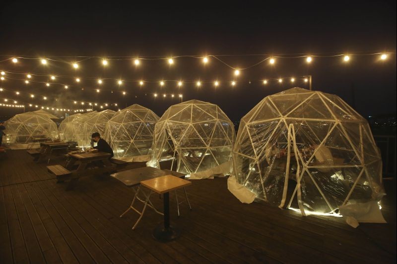Seoul: People enjoy outdoor dining at plastic bubbles, observing social distancing against the spread of the coronavirus at a restaurant near the Han River in Seoul, South Korea, Friday, April 9, 2021. AP/PTI