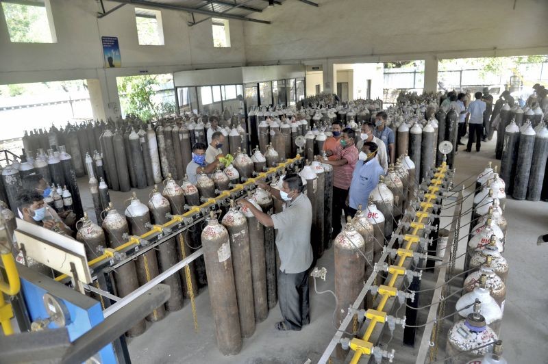 Workers at an oxygen cylinder bottling plant amidst shortage of the gas amidst the COVID-19 pandemic situation, in Sangli on April 30, 2021. (PTI Photo)