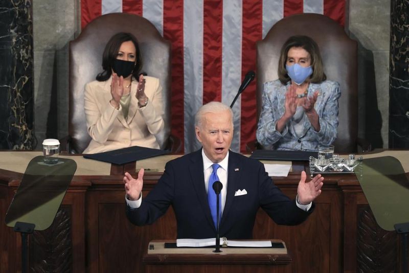 President Joe Biden addresses a joint session of Congress, Wednesday, April 28, 2021, in the House Chamber at the U.S. Capitol in Washington, as Vice President Kamala Harris, left, and House Speaker Nancy Pelosi of Calif., look on. (AP Photo))