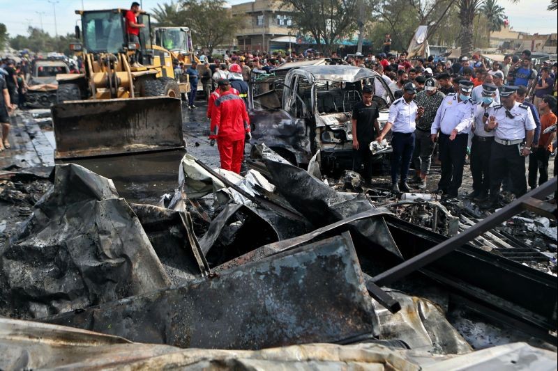 People and security forces inspect the scene of an explosion at a crowded outdoor used furniture market in Sadr City area, Iraq on April 15, 2021. The powerful explosion rocked the market in east Baghdad on Thursday, killing at least one person and injuring many others, according to Iraq's military. The cause of the blast was not immediately known. (AP/PTI Photo)