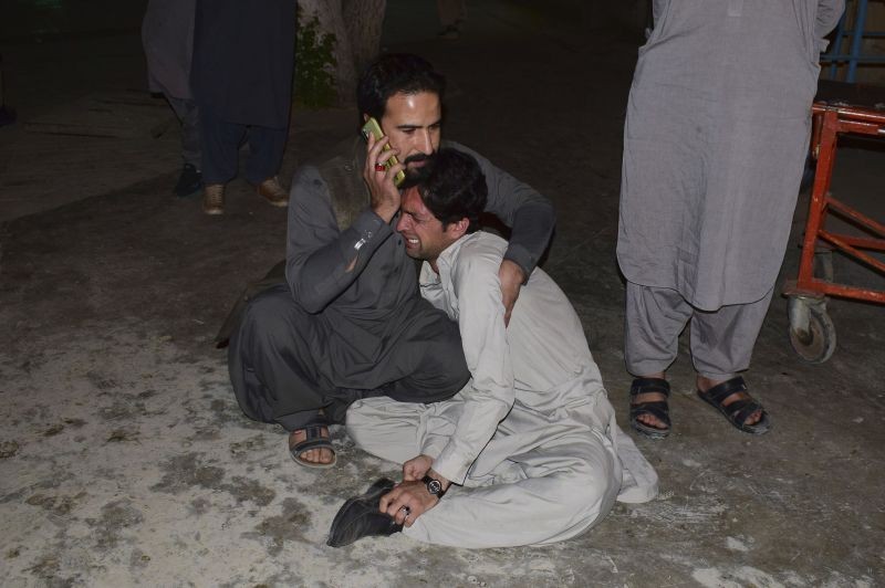 A Pakistani comforts to another mourning over the death of his family member in a bomb blast, at a hospital in Quetta, Pakistan on April 21, 2021. A powerful bomb went off in the parking area of a five-star Serena hotel in the southwestern city of Quetta on Wednesday, wounding some people, police said. (AP/PTI Photo)