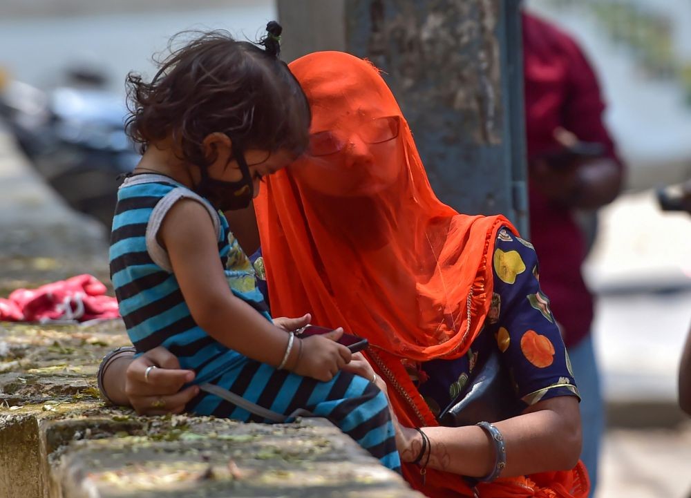 Bengaluru: A mother and her daughter wait to undergo COVID-19 tests, amid a surge in coronavirus cases in Bengaluru, Saturday, April 10, 2021. (PTI Photo/Shailendra Bhojak)