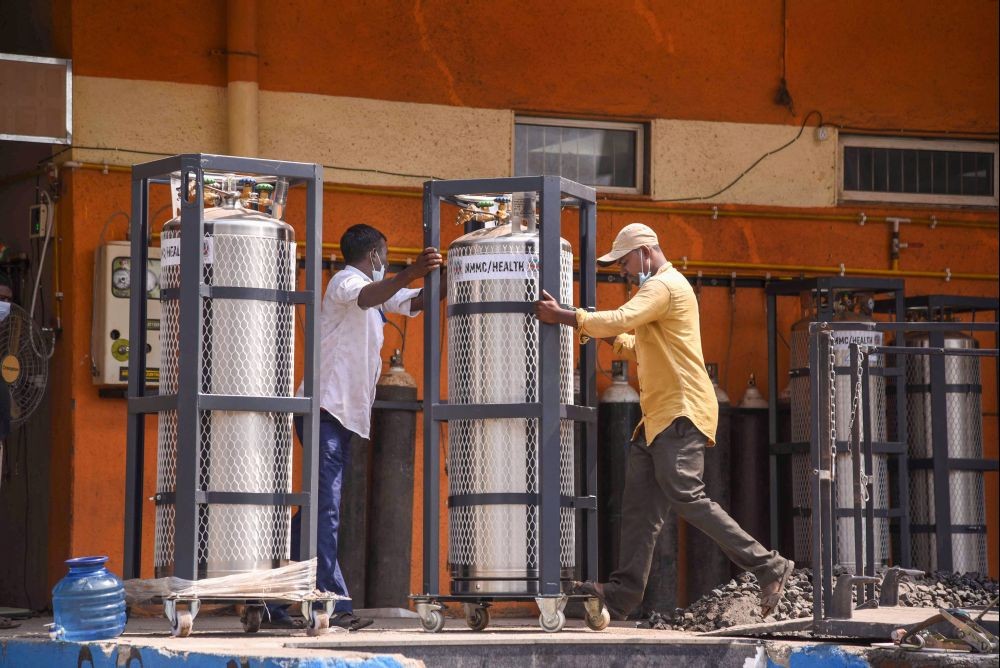 Mumbai: Workers unload oxygen cylinders at NMMC's Covid Care Center in Mumbai,  Tuesday, April 27, 2021. (PTI Photo)