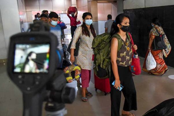 Passengers undergo digital scanning to check body temperature in view of COVID-19, at Guwahati Railway Station. PTI Photo