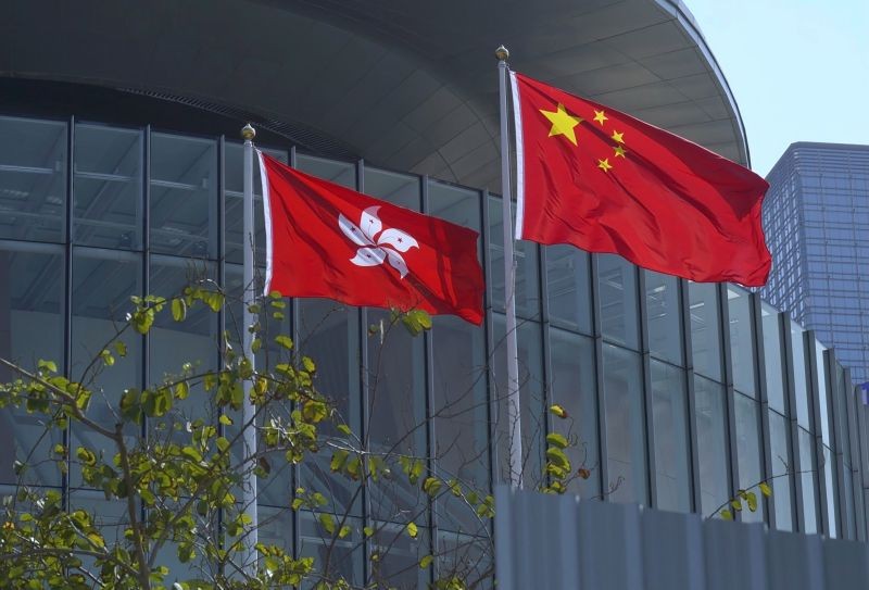 A China national flag, right, and a Hong Kong flag flutter at the Legislative Council in Hong Kong on April 13, 2021. (AP/PTI Photo)