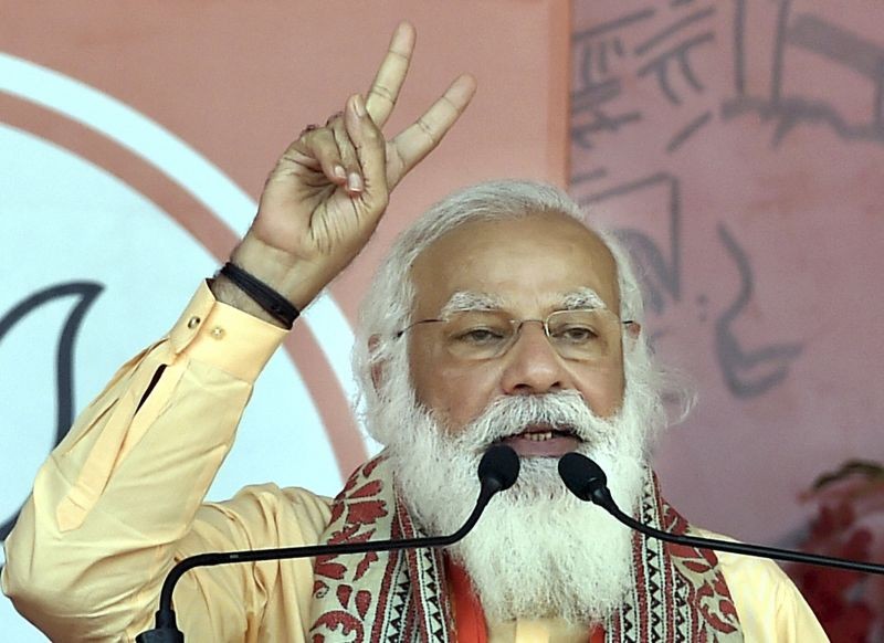 South 24 Parganas: Prime Minister Narendra Modi flashes the victory sign as he addresses during an election campaign rally in support of his party candidates, during the ongoing West Bengal assembly polls, at Joynagar in South 24 Parganas district, Thursday, April 1, 2021. (PTI Photo/Swapan Mahapatra)