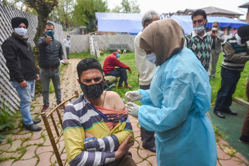 A man receives a shot of COVID-19 vaccine, as cases continued to surge across the country, in Srinagar on April 20, 2021. (PTI Photo)