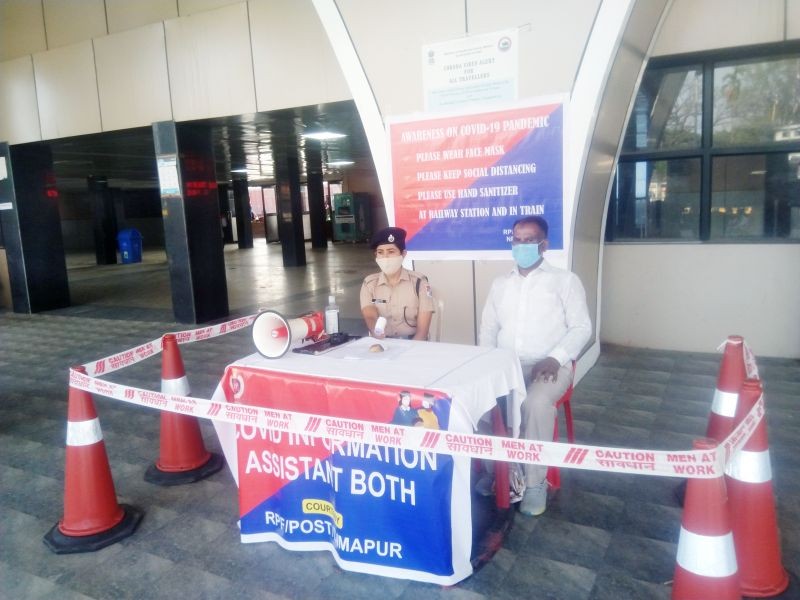 Two Railway Protection Force personnel are seen at a ‘COVID-19 assistant booth’ set up at the entrance of the Dimapur Railway Station on April 24. (Morung Photo)