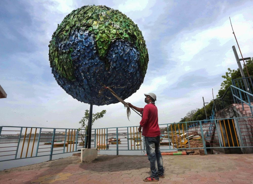 Bhopal: Replica of Earth being cleaned by a worker on the banks of Upper Lake in Bhopal, Thursday, April 22, 2021. Earth Day is being observed to demonstrate support to environmental protection for the theme ‘Restore Our Earth’. (PTI Photo)