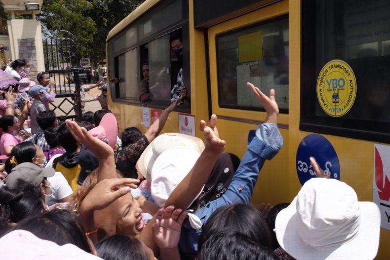 A crowd waves to people onboard a bus that drove out of Insein prison in Yangon, Myanmar Saturday, April 17, 2021. Myanmar's junta on Saturday announced it pardoned and released more than 23,000 prisoners to mark the new year holiday, but it wasn't immediately clear if they included pro-democracy activists who were detained in the wake of the February coup. (AP Photo)