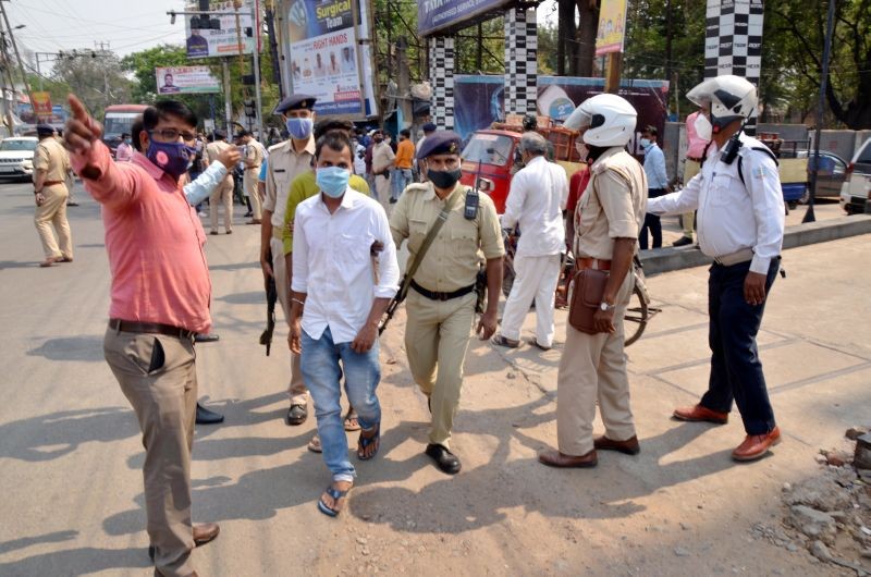 Police personnel detain people for not wearing masks, amid countrywide spike in COVID-19 cases, in Ranchi district on April 7. (PTI Photo)