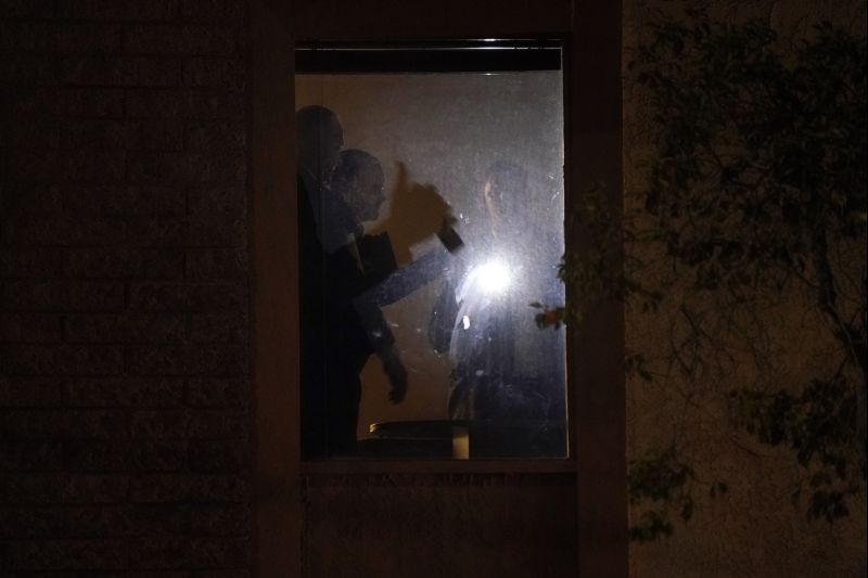 Investigators survey the scene in an office building after a shooting in Orange, Calif. on March 31, 2021. The shooting killed several people, including a child, and injured another person before police shot the suspect, police said. (AP/PTI Photo)