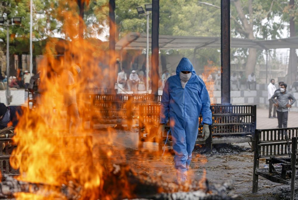 Ahmedabad: A relative reacts during the cremation of a family member who died of COVID-19, as coronavirus cases surge in Ahmedabad, Tuesday, April 20, 2021. (PTI Photo)
