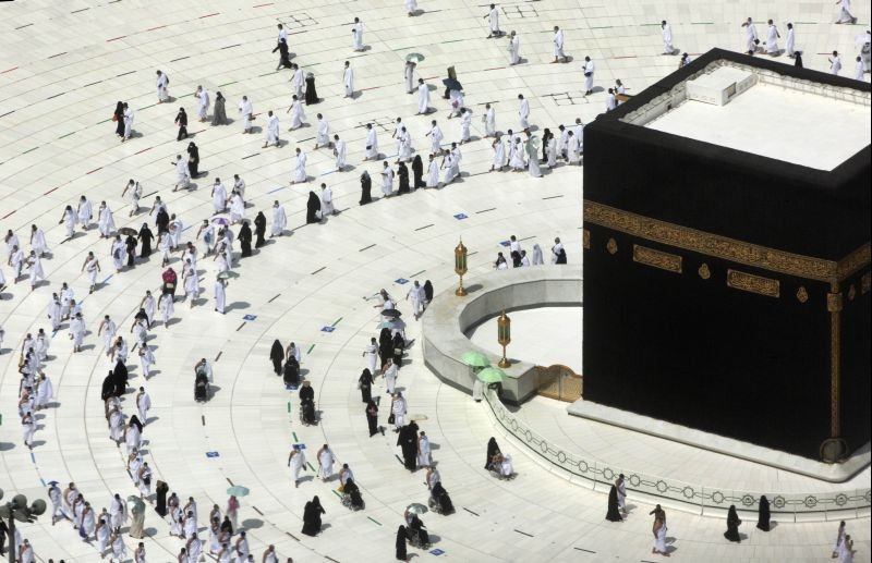 Muslim pilgrims circumambulate around the Kaaba, the cubic building at the Grand Mosque, during the minor pilgrimage, known as Umrah, marking the holy month of Ramadan, in the Muslim holy city of Mecca, Saudi Arabia on April 13, 2021. During Ramadan, the holiest month in Islamic calendar, Muslims refrain from eating, drinking, smoking and sex from dawn to dusk.. (AP/PTI Photo)