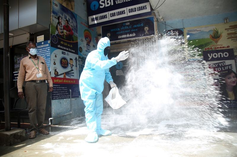 Corporation worker sanitize a locality, where a Vadiveswram SBI bank manager was detected with COVID-19, amid the rise in Covid-19 cases across the country, in Nagercoil on April 15, 2021. (PTI Photo)