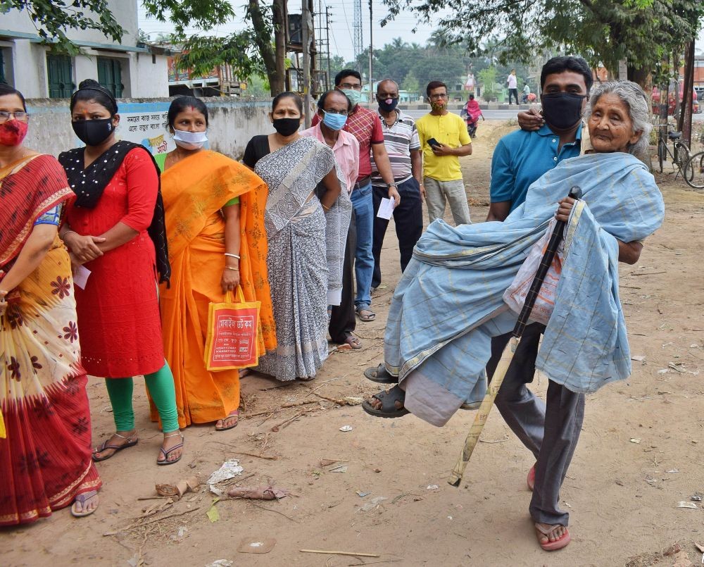 Nadia: An elderly woman being brought at a polling booth to cast her vote for the 6th phase of West Bengal Assembly polls, in Nadia, Thursday, April 22, 2021.  (PTI Photo) Abhi Ghosh