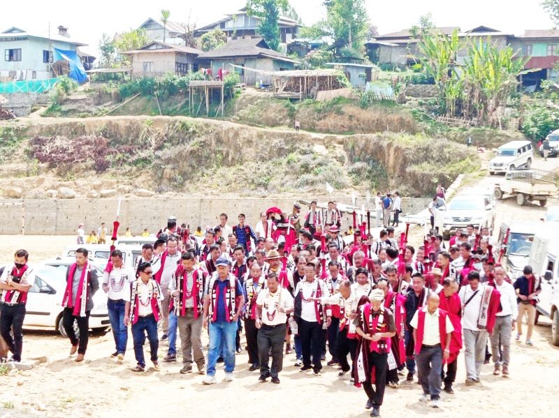 Mopungchuket village elders made a traditional goodwill visit of ‘Aksü’ to Mongsenyimti village today where the two major Ao Naga villages avowed to re-strengthen historical ties and rebuild cordial relations between them. Seen in the picture are elders of the two villages in a customary procession called ‘yimdongmak.’  They are seen here proceeding from a Mongsenyimti village elder's residence to another for ‘kimak’ where they engaged in a participatory belting of folk songs. (Morung Photo)