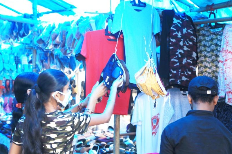 Shoppers examine fabric face masks on sale at a market in Dimapur. (Morung File Photo for representational purpose)