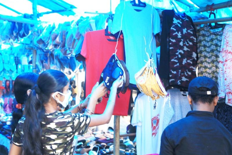 Shoppers examine fabric face masks on sale at a market in Dimapur. (Morung File Photo for representational purpose)