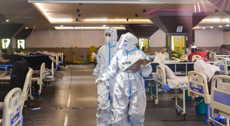 Medics inspect COVID-19 patients at Shehnai Banquet Hall, temporarily converted into an isolation ward, as coronavirus cases surge across the country, in New Delhi on April 23, 2021. (PTI Photo)