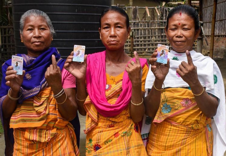 Morigaon: Women, belonging to a tribal community, show their fingers marked with indelible ink after casting vote, during the 2nd phase of Assam assembly polls, at Sildubi in Morigaon district, Thursday, April 1, 2021. (PTI Photo