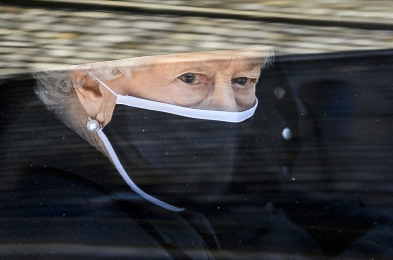 In this Saturday April 17, 2021 file photo, Britain's Queen Elizabeth II follows the coffin in a car as it makes it's way past the Round Tower during the funeral of Britain's Prince Philip inside Windsor Castle in Windsor, England. Now that the Royal Family has said farewell to Prince Philip, attention will turn to Queen Elizabeth II’s 95th birthday on Wednesday, April 21 and, in coming months, the celebrations marking her 70 years on the throne. This combination of events is reminding the United Kingdom that the reign of the queen, the only monarch most of her subjects have ever known, is finite. (AP Photo)