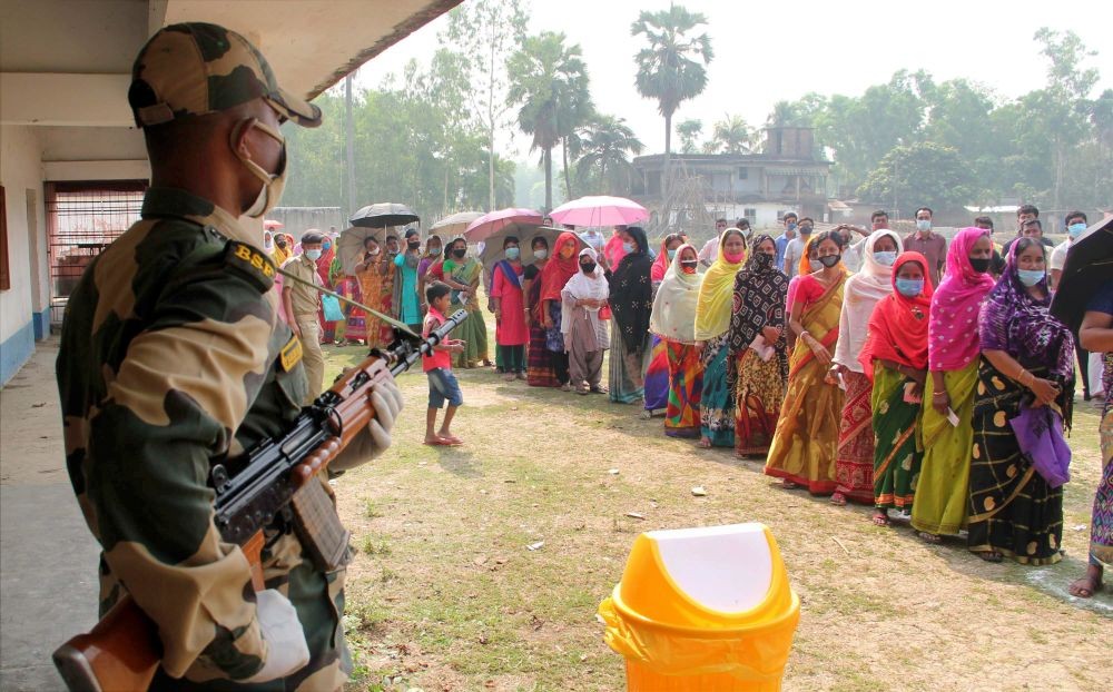 South Dinajpur: Voters wait in queues to cast votes at a polling station during the 7th phase of West Bengal Assembly elections at a village near Balurghat in South Dinajpur district, Monday, April 26, 2021. (PTI Photo)