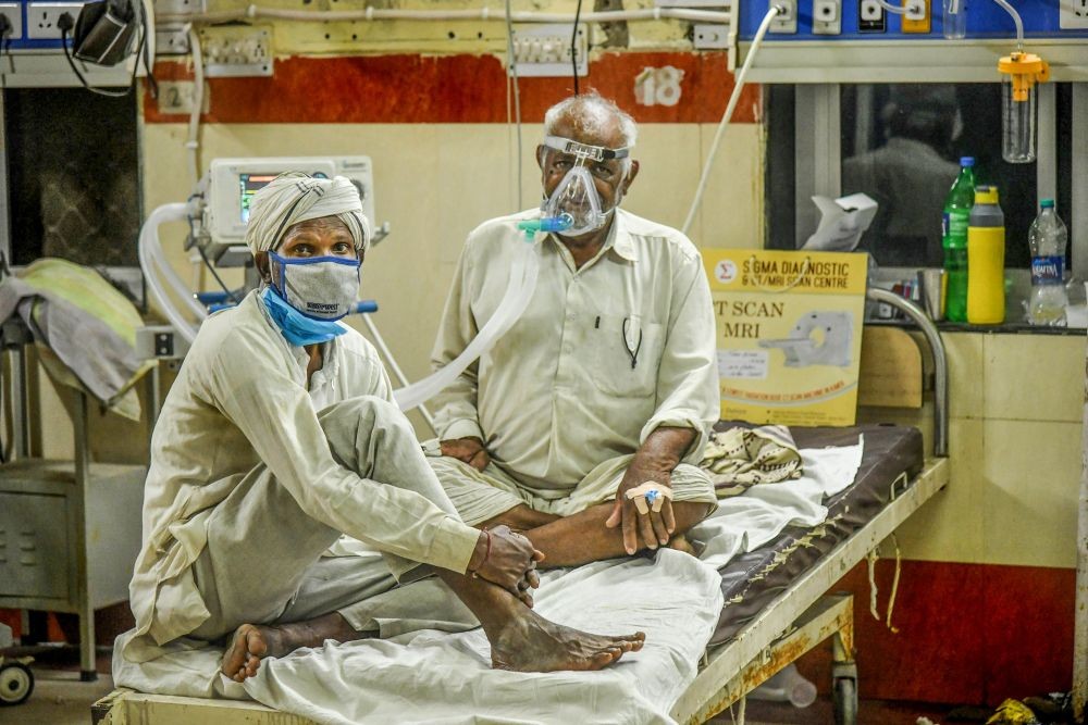 Ajmer: Patients share a bed at a COVID Care Centre as coronavirus surge in Ajmer, Tuesday, April 20, 2021. (PTI Photo)