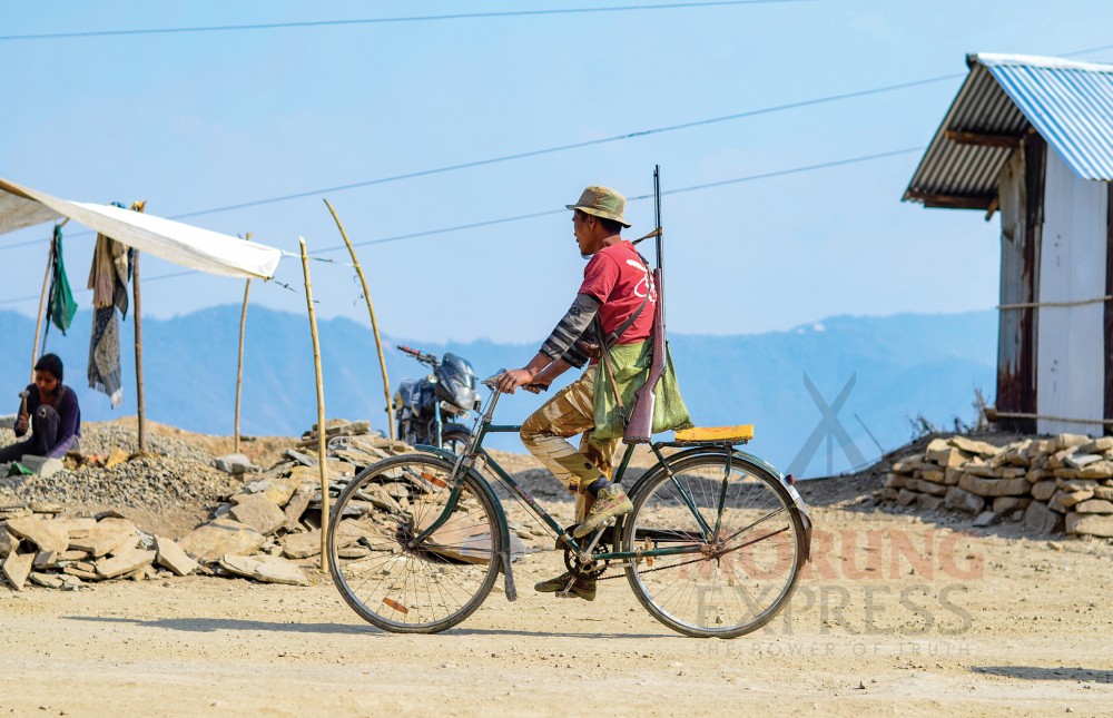 A hunter cycles past a quarry in Kuthur village in the Tuensang district. (Morung Photo by Moses Hongang Chang)