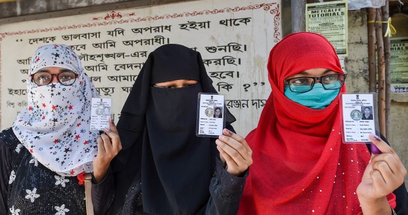 Voters show their ink marked fingers and ID cards outside a polling station after casting votes during the last phase of West Bengal Assembly Elections in Kolkata on April 29, 2021. (PTI Photo)