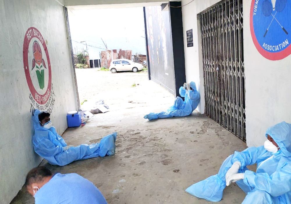 Exhausted healthcare workers taking a break in Tuensang on May 23.