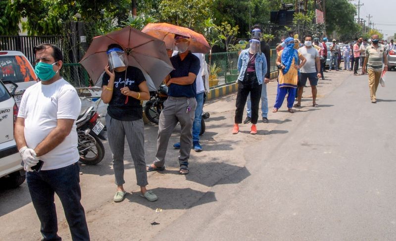 People wait in a long queue to receive COVID-19 vaccine doses, outside ESI Hospital in Noida on May 10. (PTI Photo)